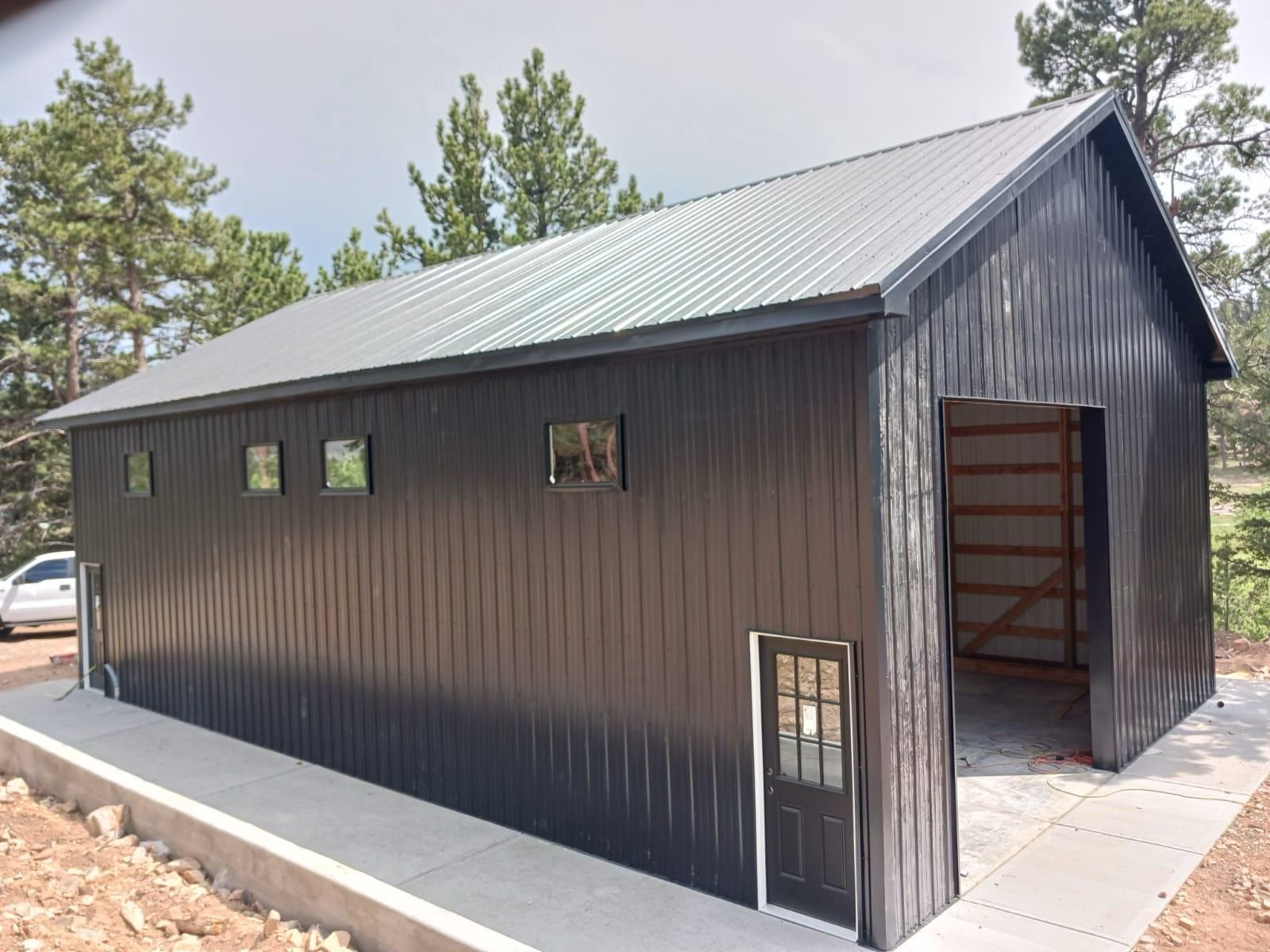 A large black building with a gray roof
