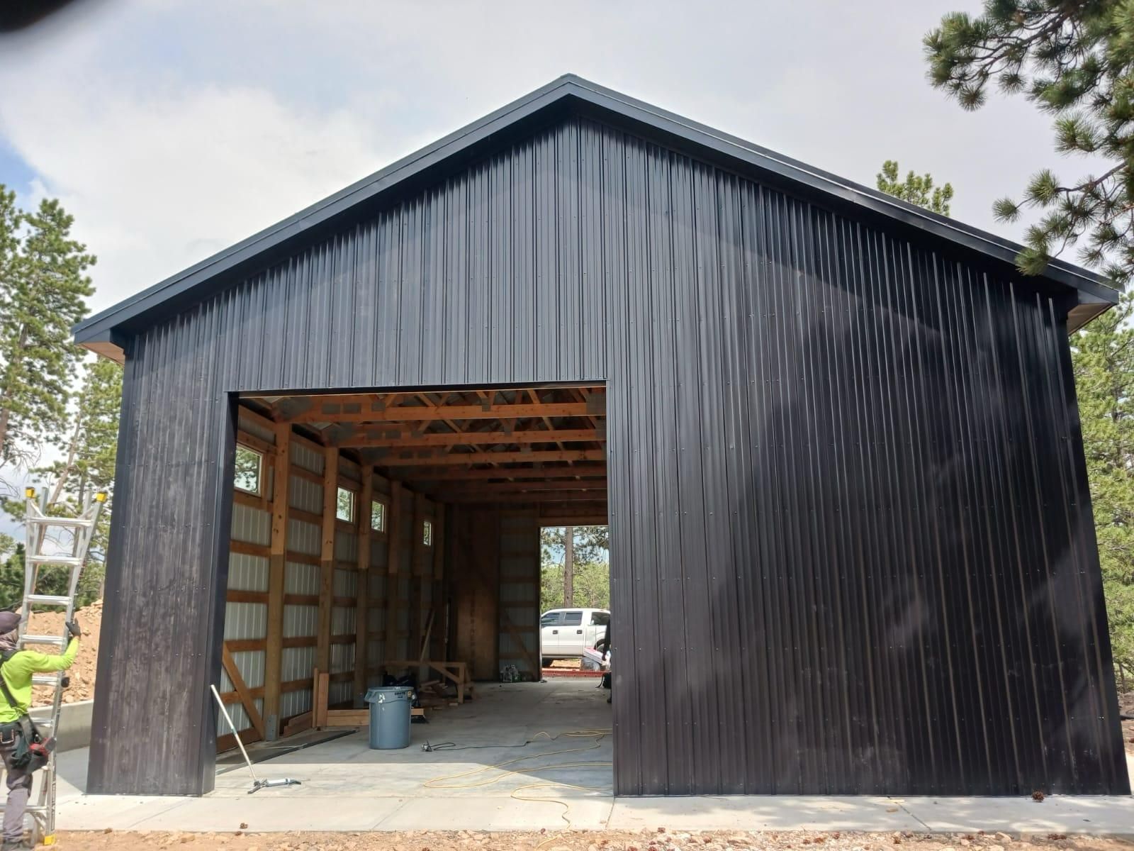 A black building with a ladder in front of it