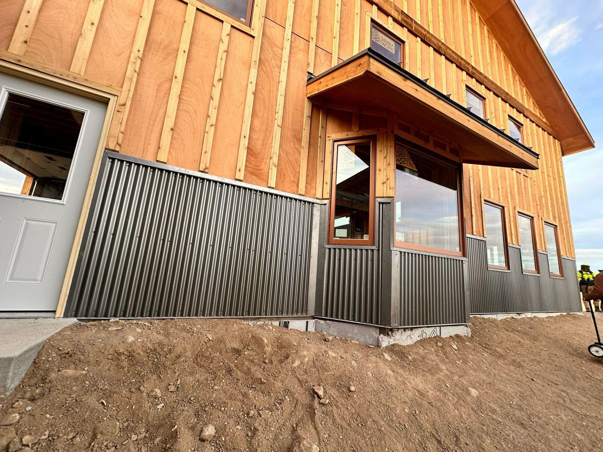 A house that is being built with a lot of windows