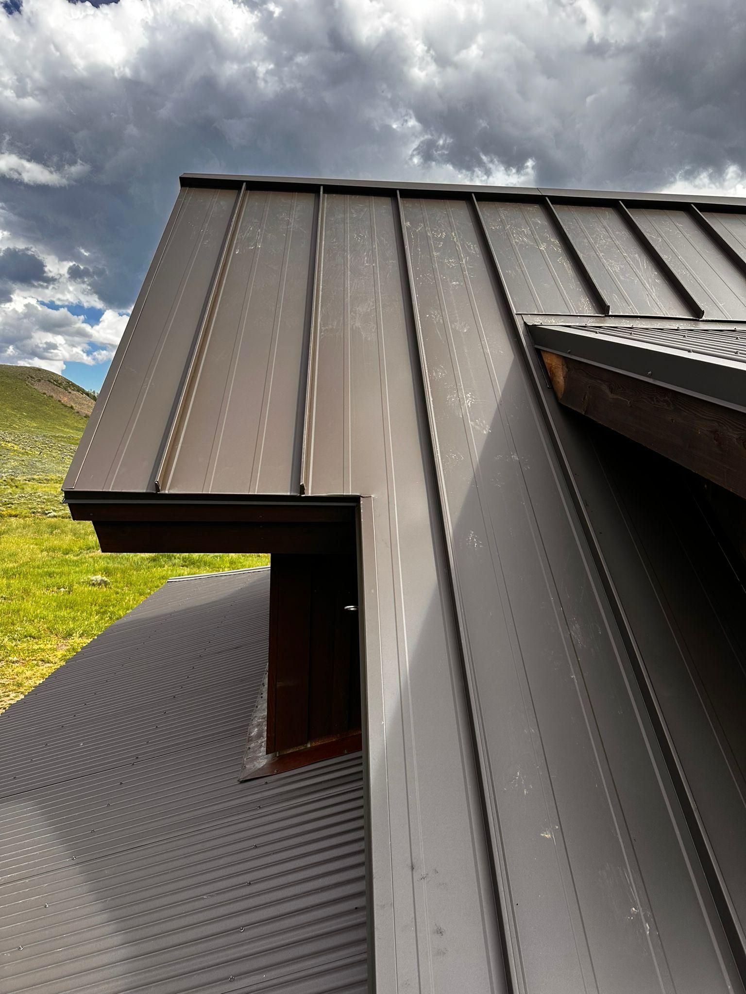 A close up of a roof with a cloudy sky in the background