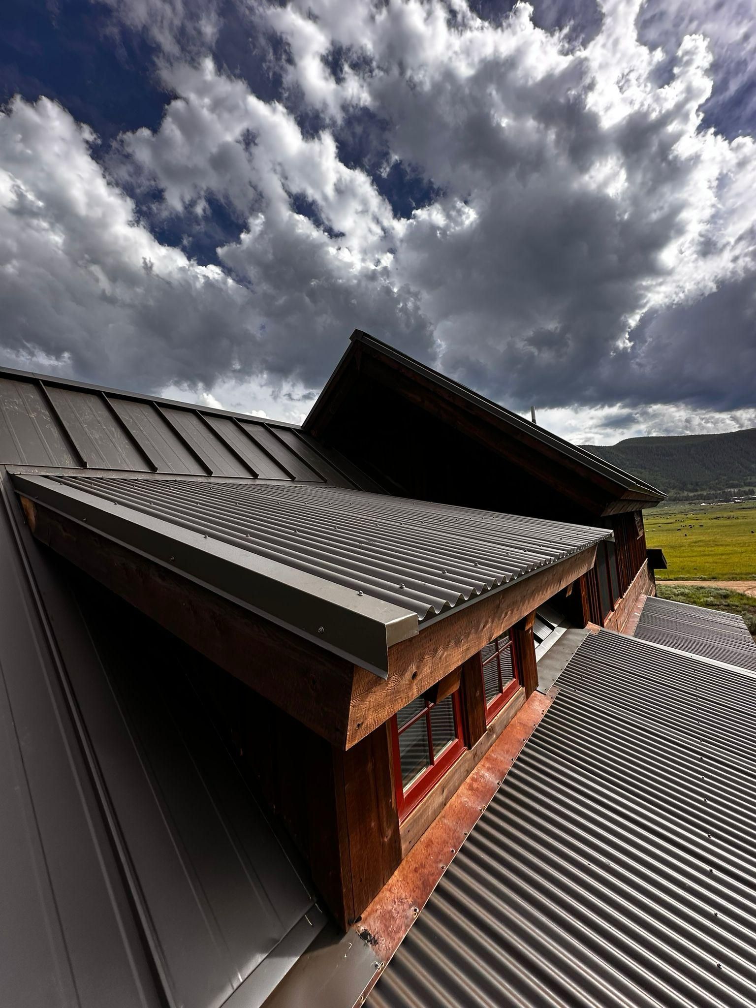 A roof with a cloudy sky in the background