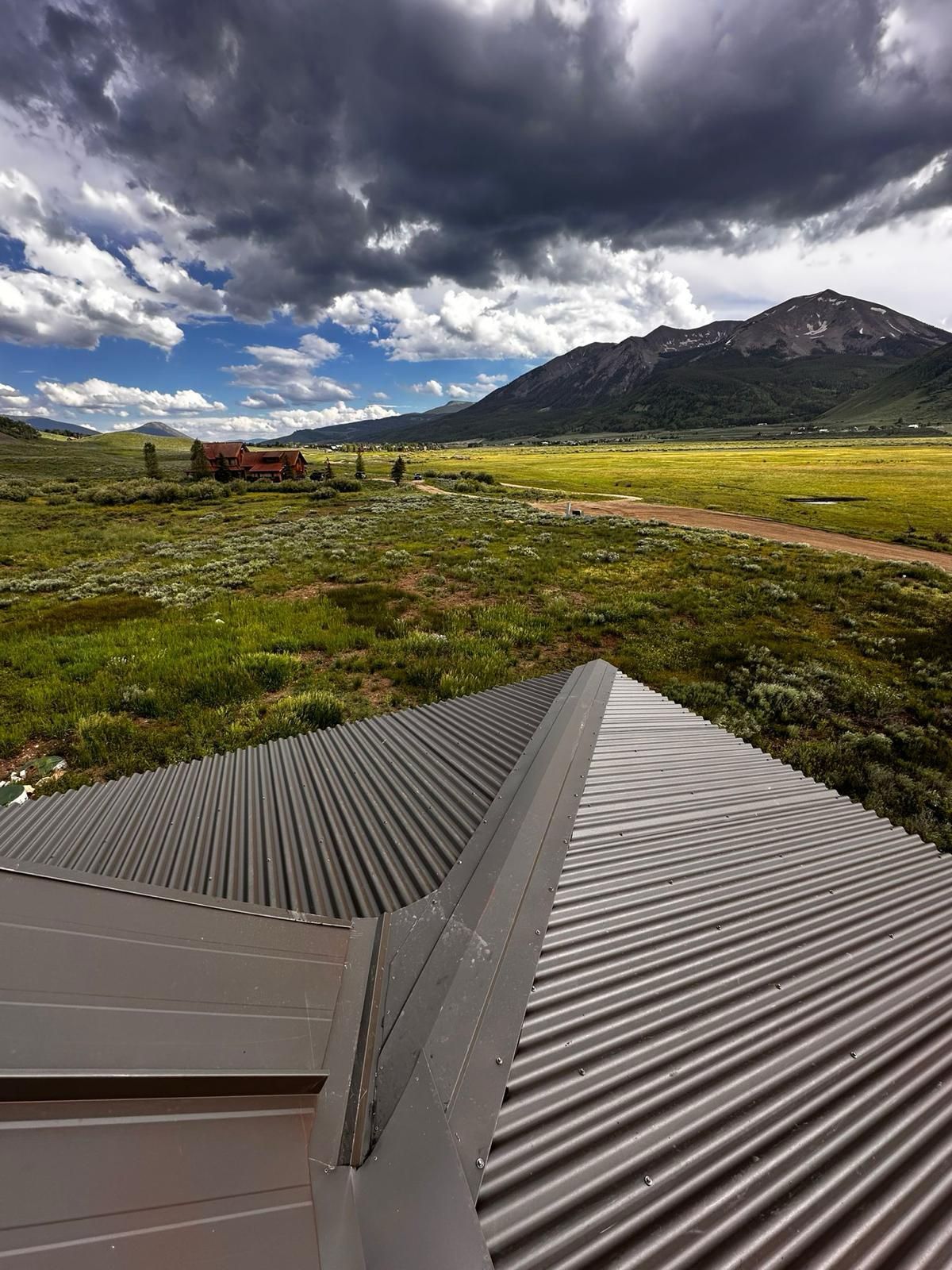 A metal roof with a mountain in the background