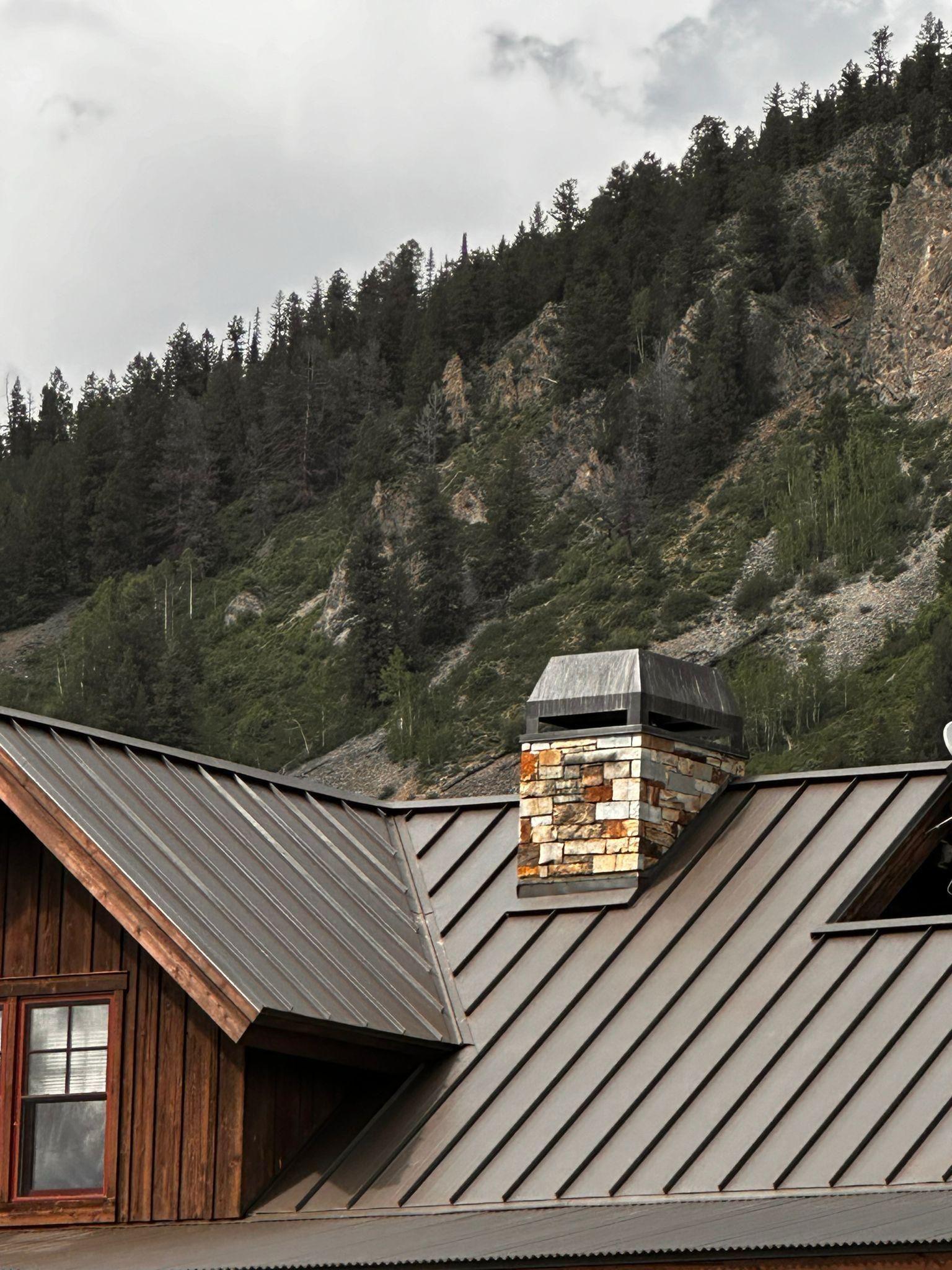A metal roof with a chimney on top of it