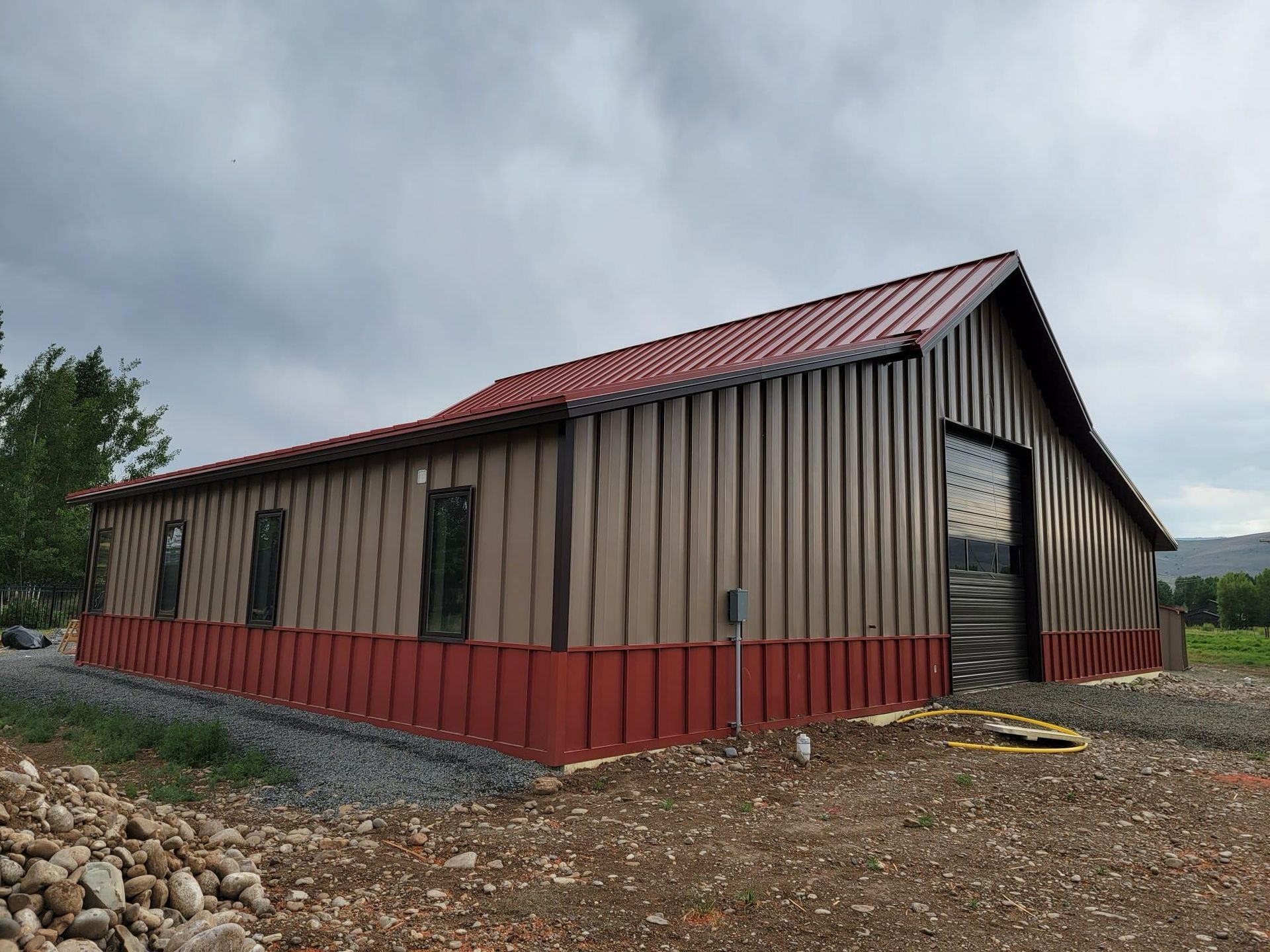 A brown and red building with a red roof
