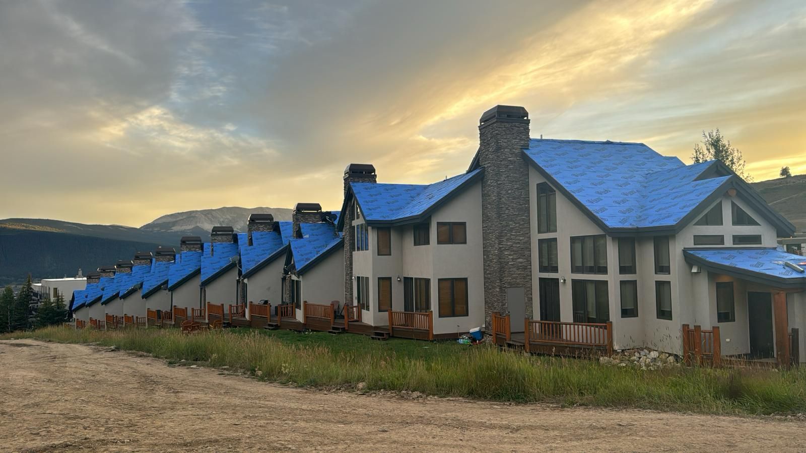 A large house with blue shingles on the roof