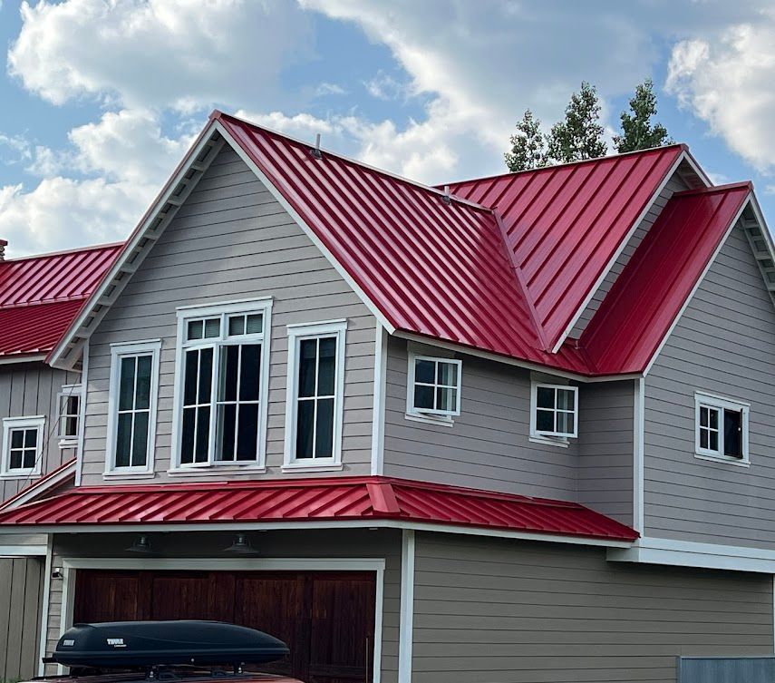 A house with a red roof and white siding