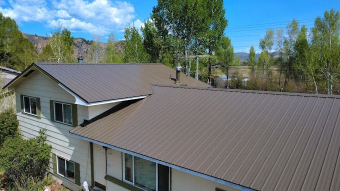 An aerial view of a house with a brown roof