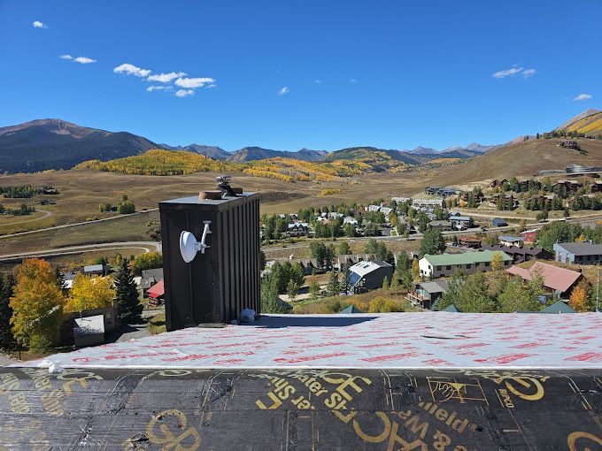 A view of a small town with mountains in the background