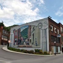 There is a large mural on the side of a building.