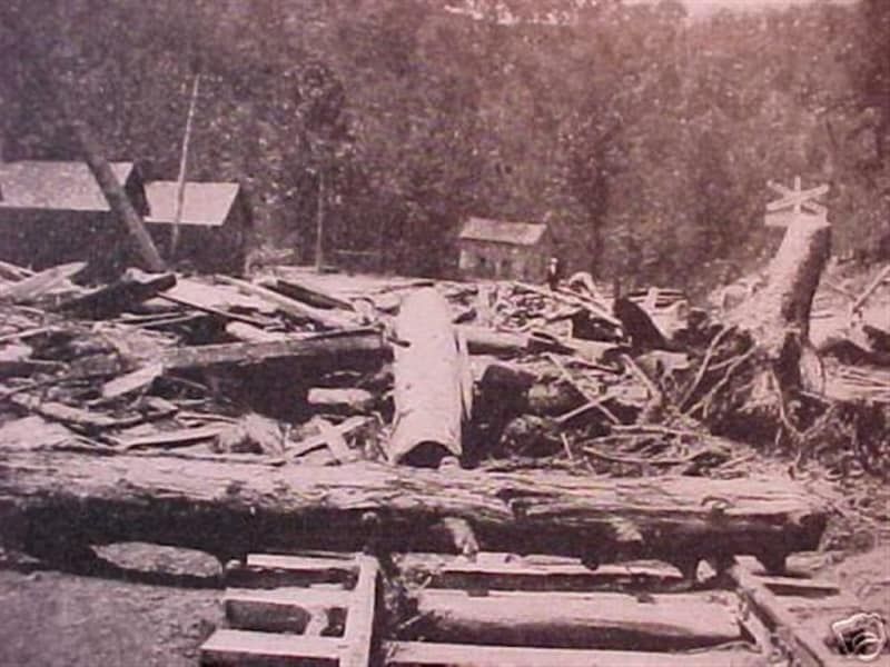 A black and white photo of a pile of logs