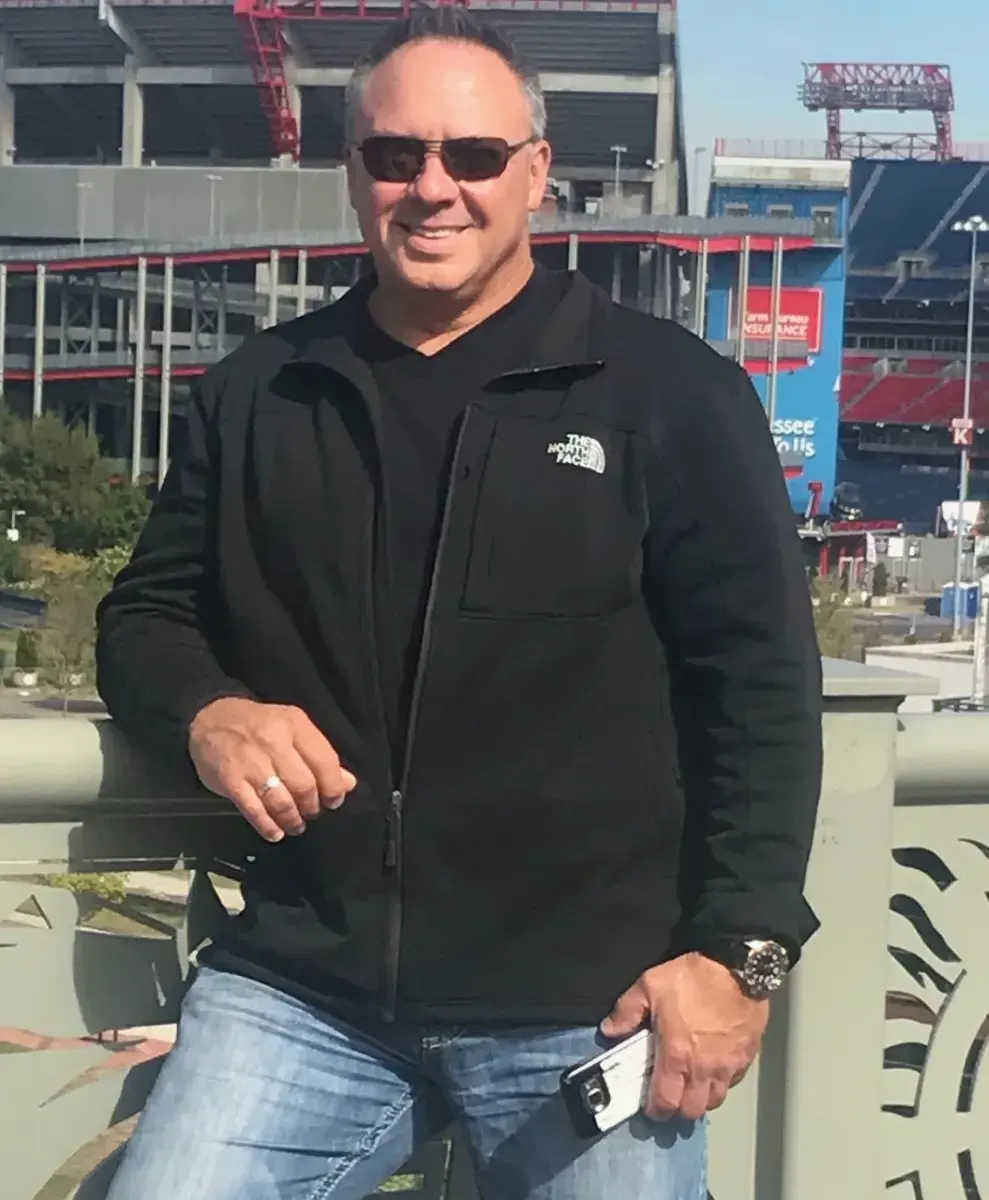 A man wearing sunglasses and a north face jacket