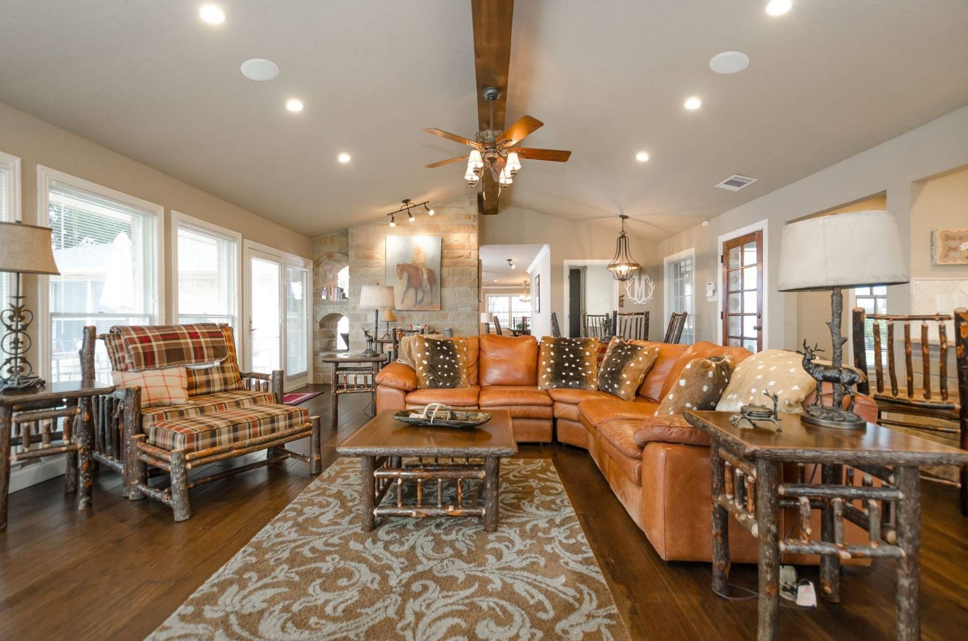 A living room filled with furniture and a ceiling fan.