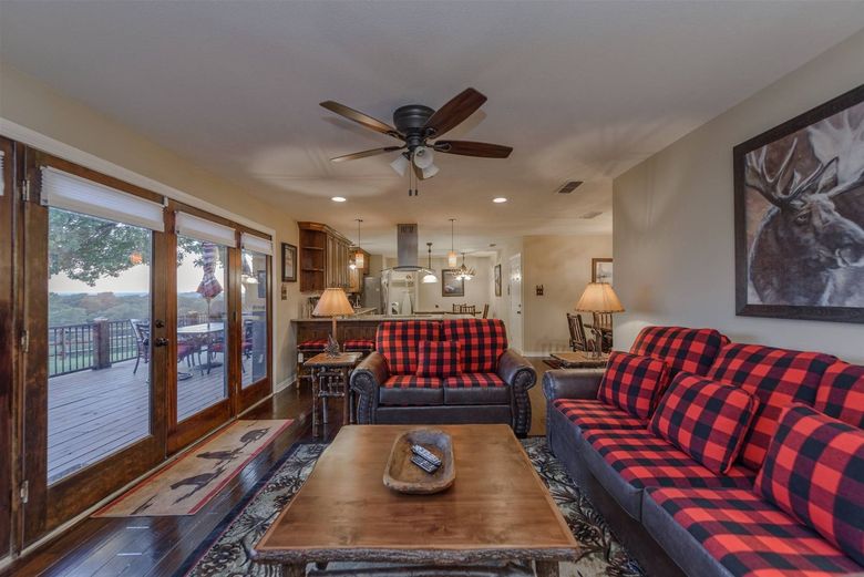 A living room with two couches , a coffee table , and a ceiling fan.