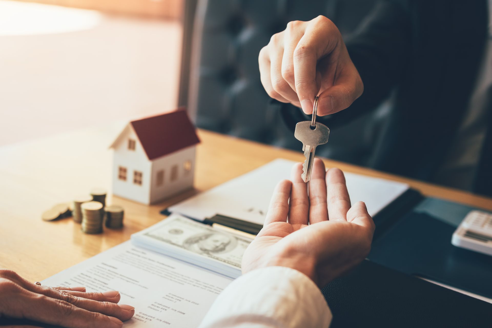 Keys being handed over during a real estate transaction.