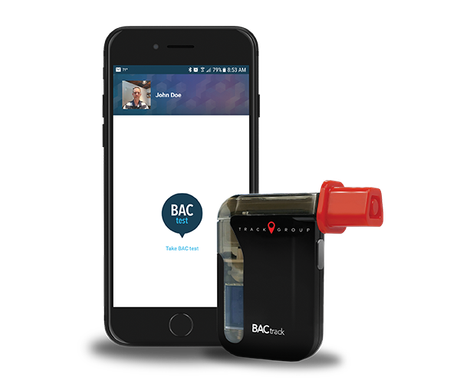 Smartphone beside BACtrack breathalyzer with red mouthpiece on white background