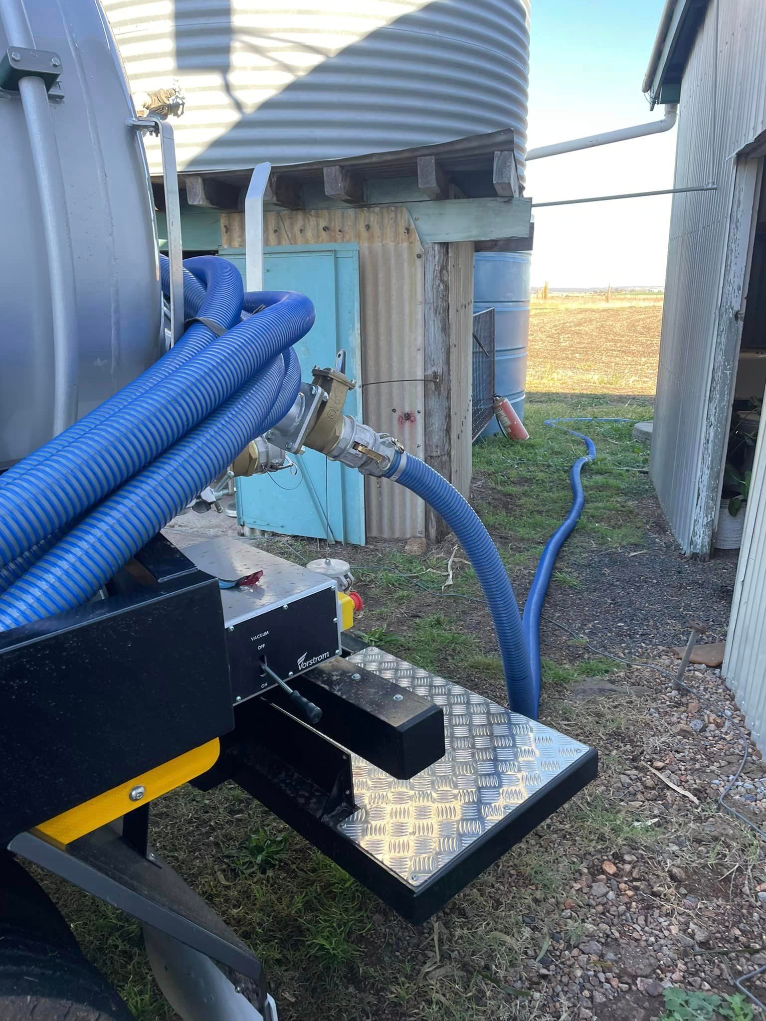 Truck Connected with Hose for Cleaning Septic Tank — All Class Liquid Waste in Oakey, QLD