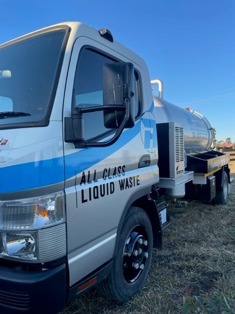 A Silver and Blue Liquid Waste Truck Parked Outdoors — All Class Liquid Waste in Oakey, QLD