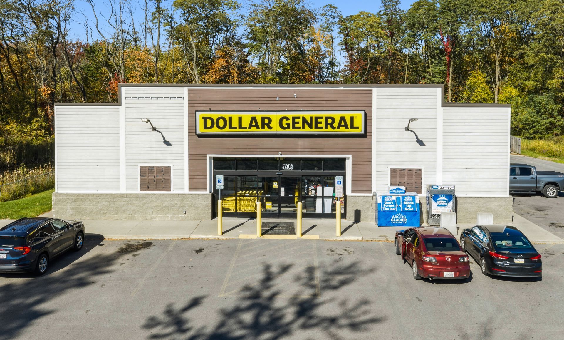 Dollar General storefront with parked cars in front on a sunny day