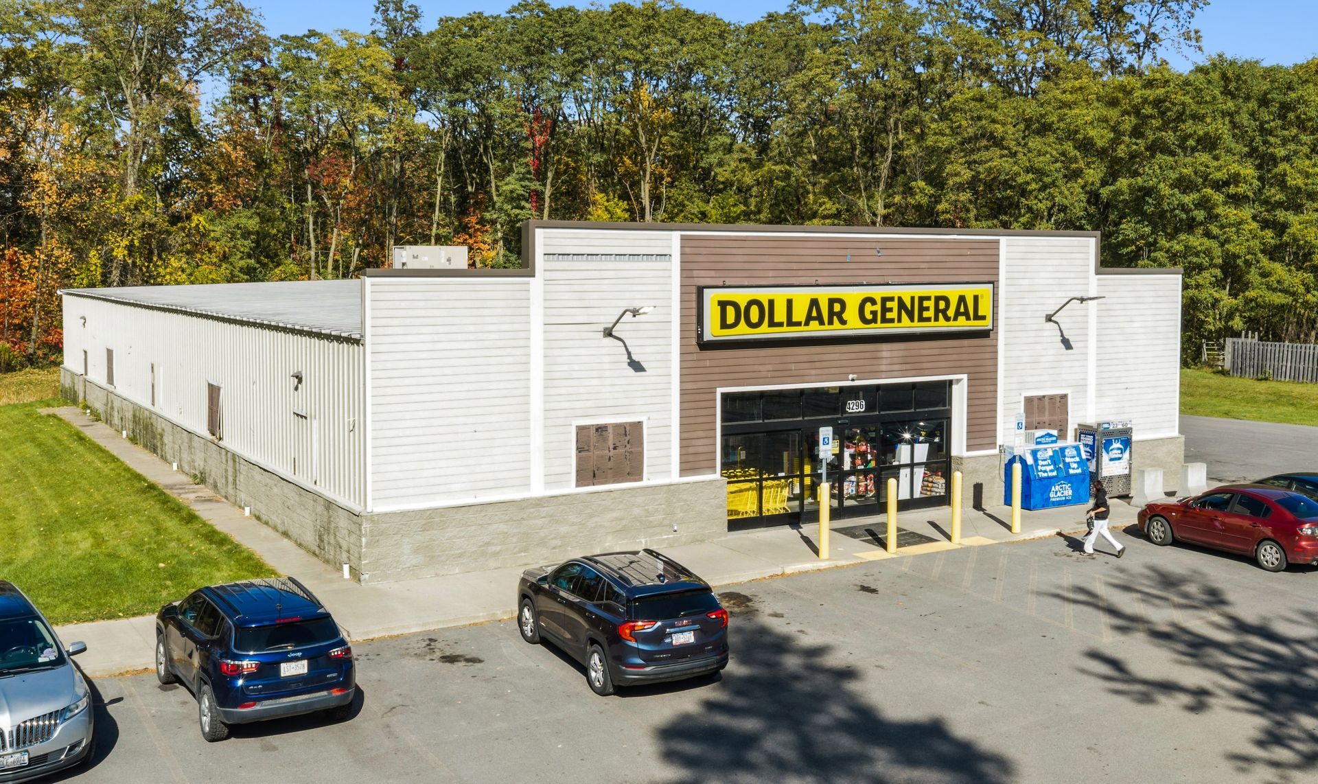 Dollar General storefront with parked cars in front, viewed from above