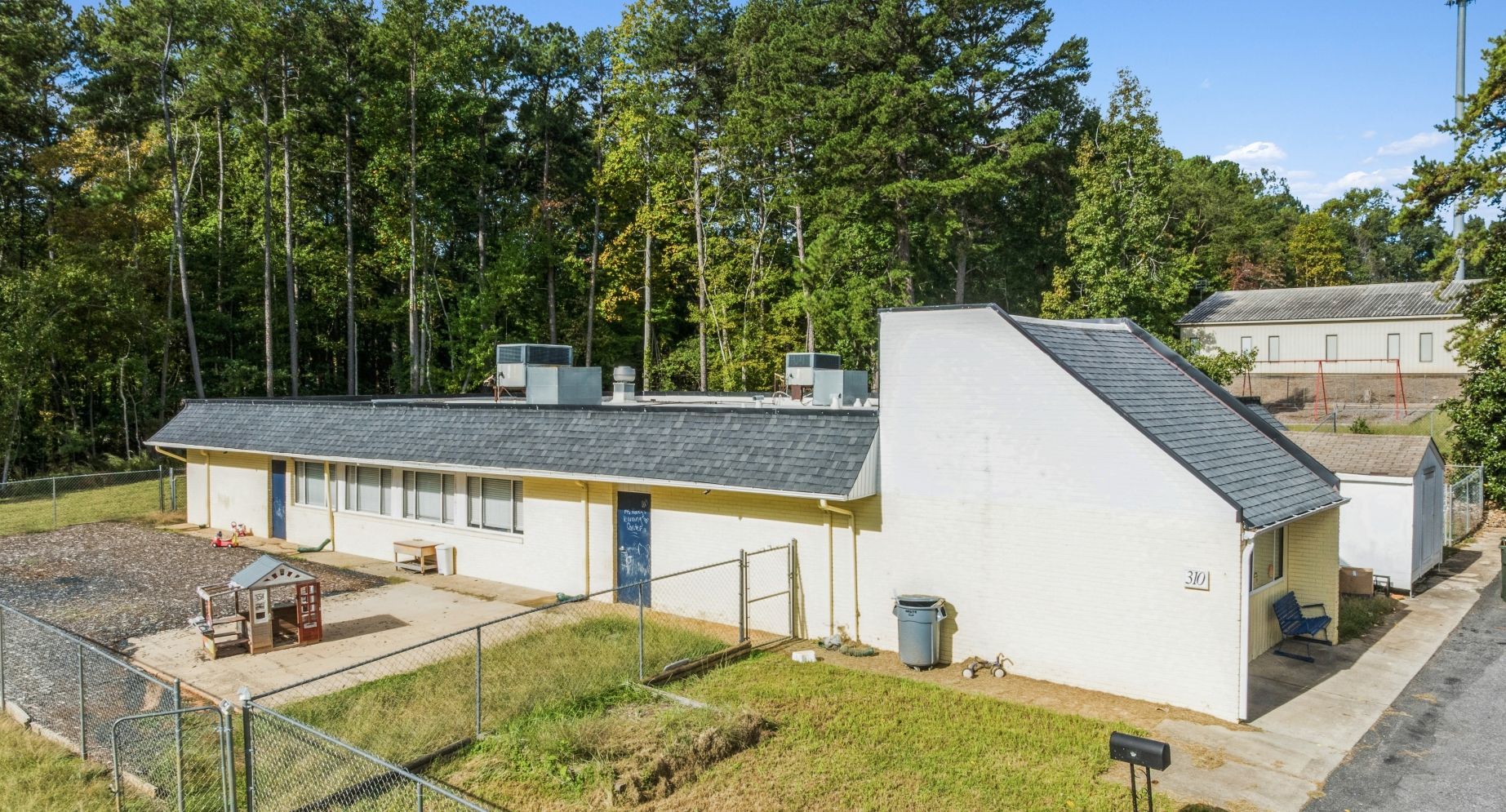 A white building with a blue awning and the word davita on it