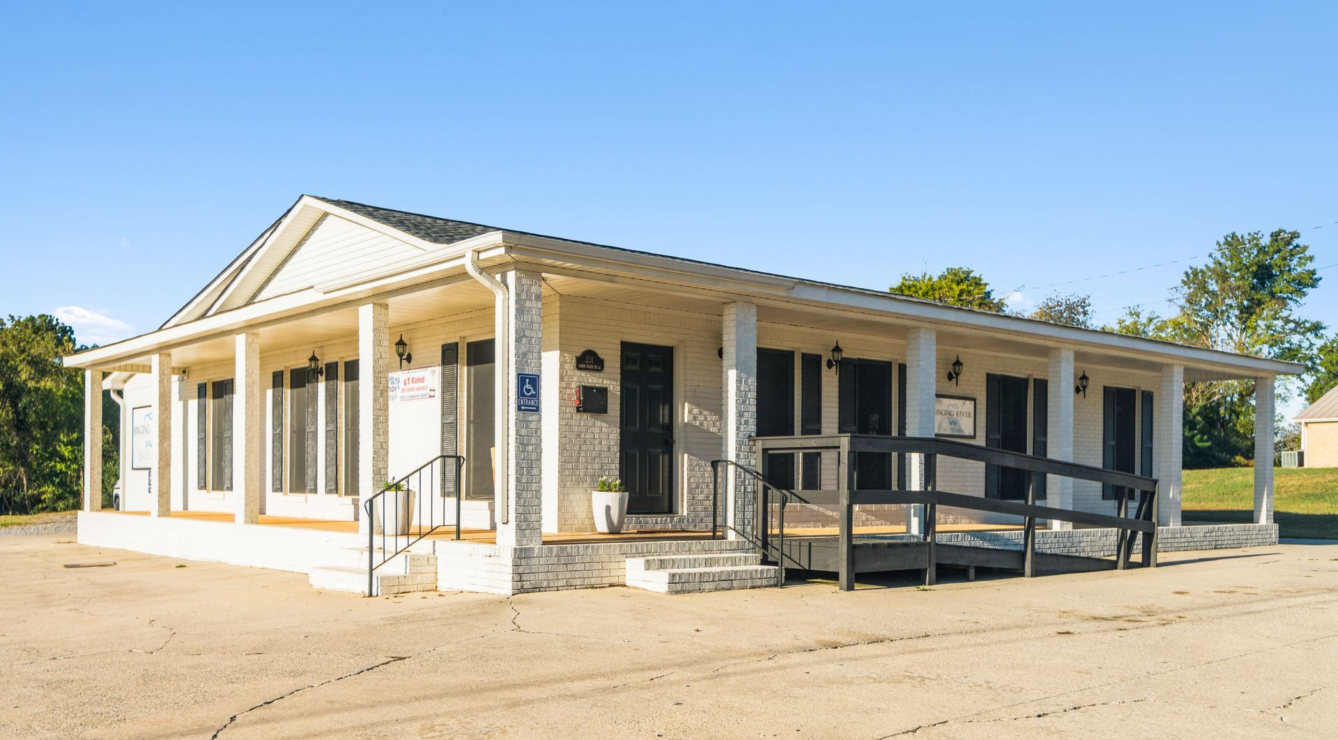A white building with a blue awning and the word davita on it