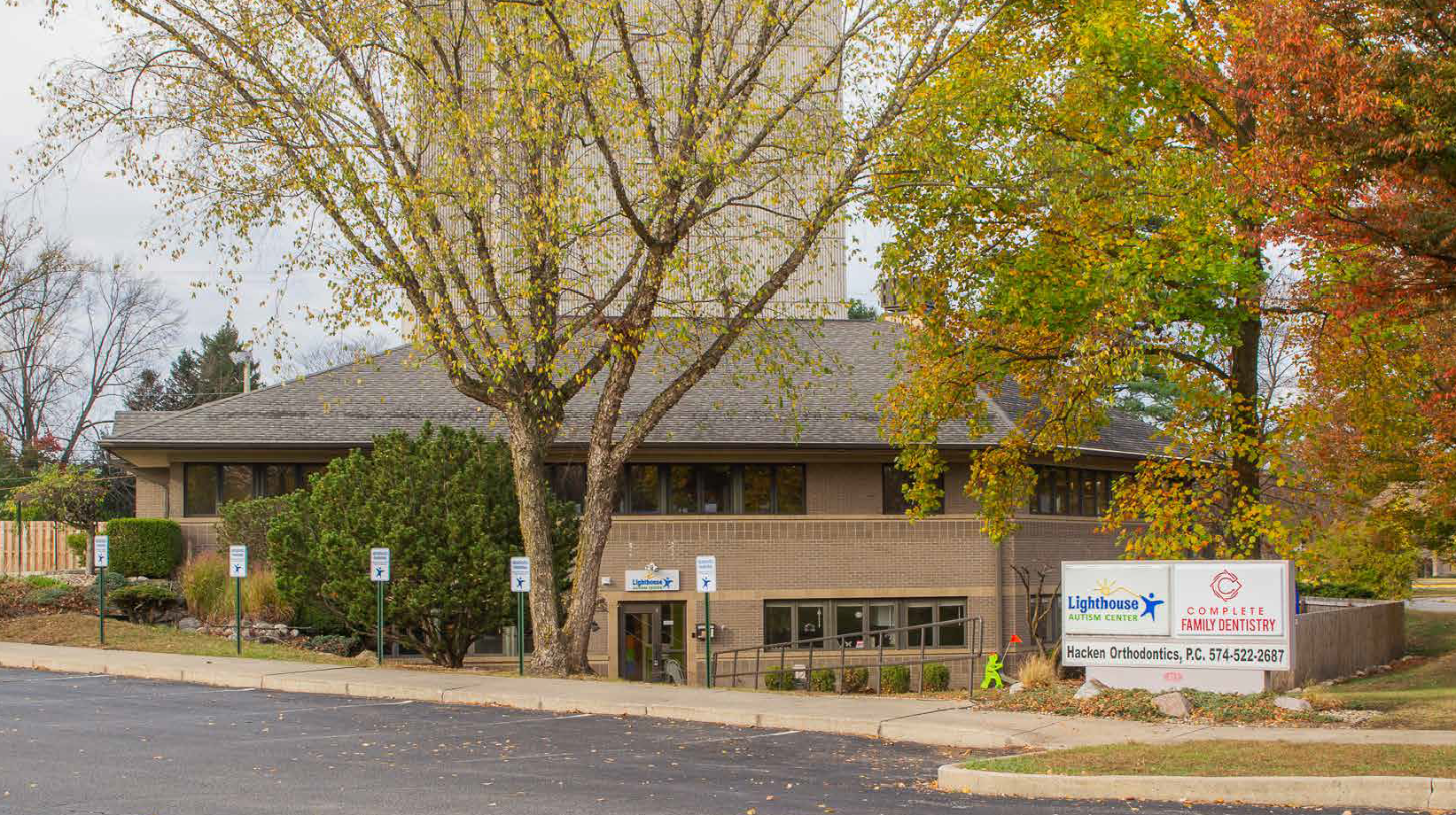 A large building with a lot of trees in front of it.