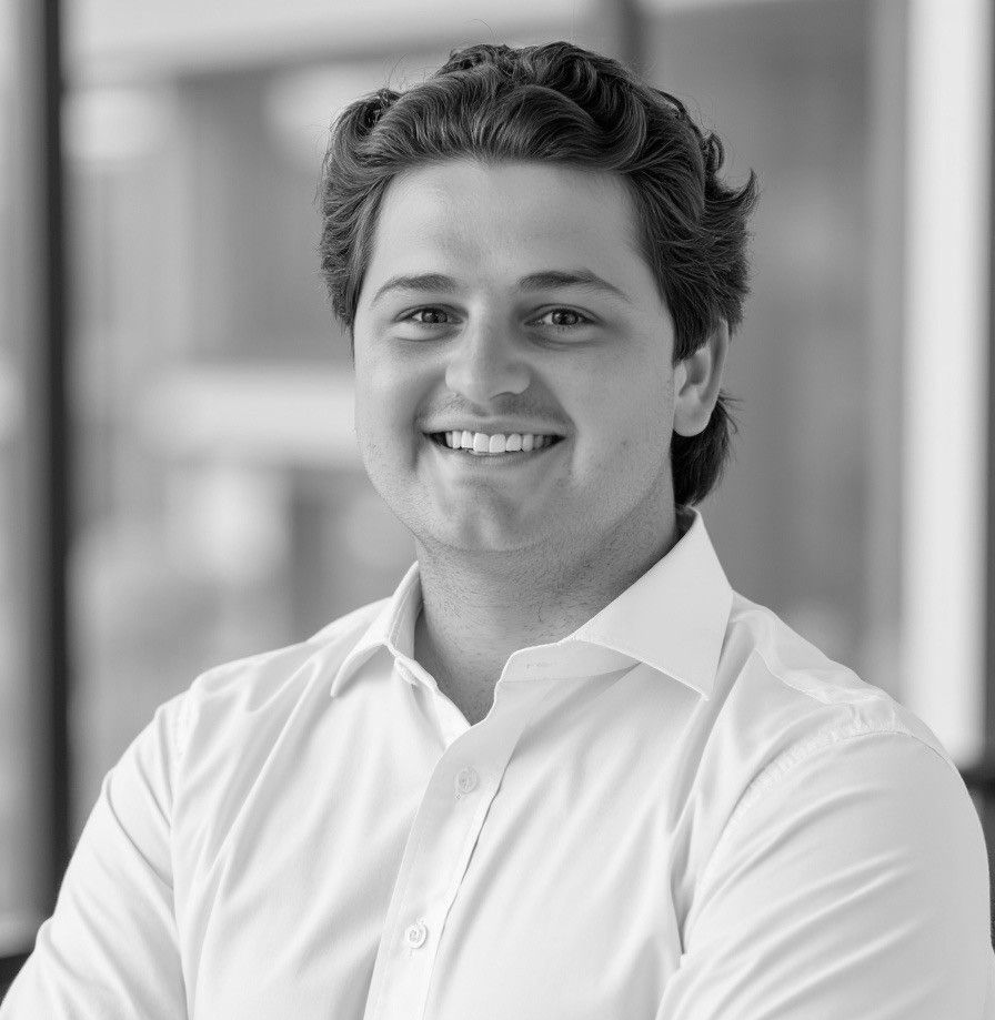 Harrison Warr smiles at the camera against a plain background.