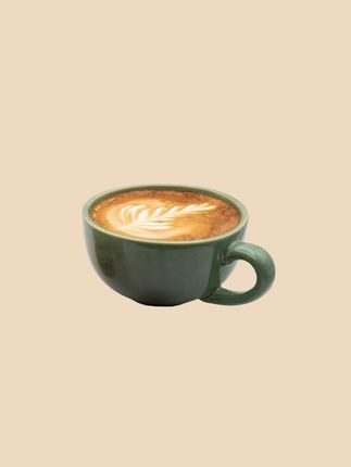 A cup of cappuccino on a beige background.