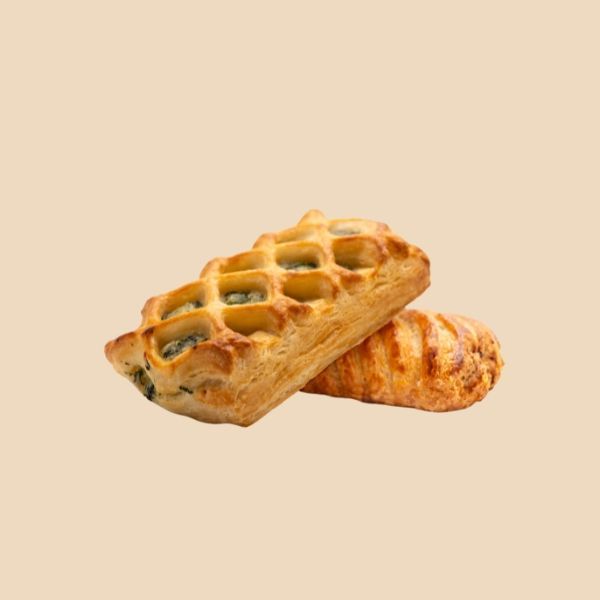 Two pastries are sitting on top of each other on a table.