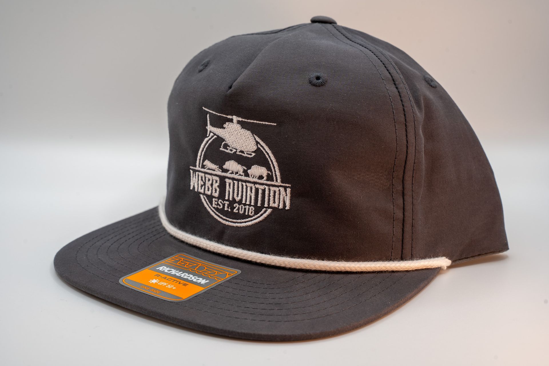 Black baseball cap with white logo and orange sticker on the brim, shown on a light background