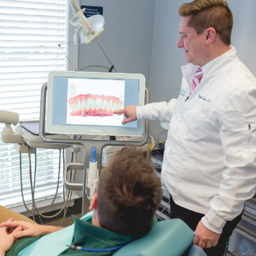 Doctor showing patient digital image of smile