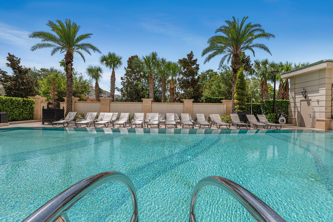 Outdoor apartment community pool with lounge chairs and palm trees at Olympus Harbour Island, offering downtown Tampa apartments and penthouses for rent.
