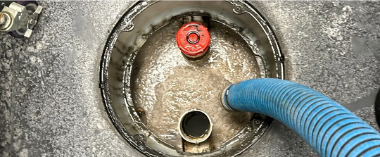 Commercial grease management technicians servicing a large grease trap