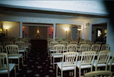 Rows of chairs are lined up in an empty room