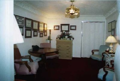 A living room with a table chairs and a dresser