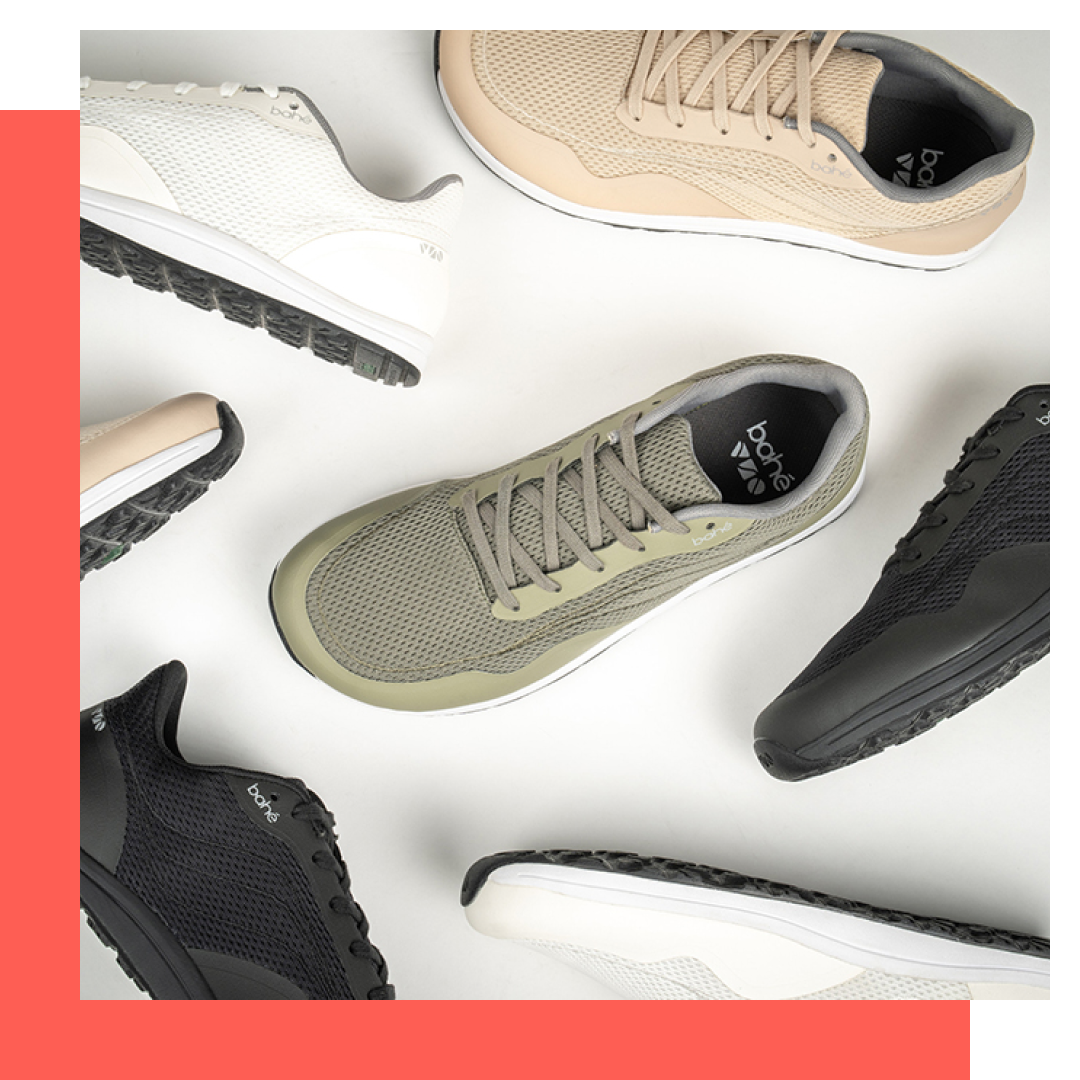 Assorted sneakers in various colors (white, beige, black, and olive green) arranged on a white surface.