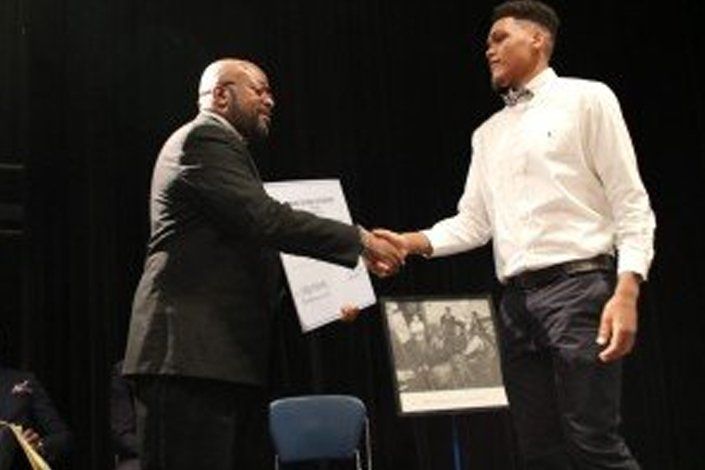 George Love shaking hands to student