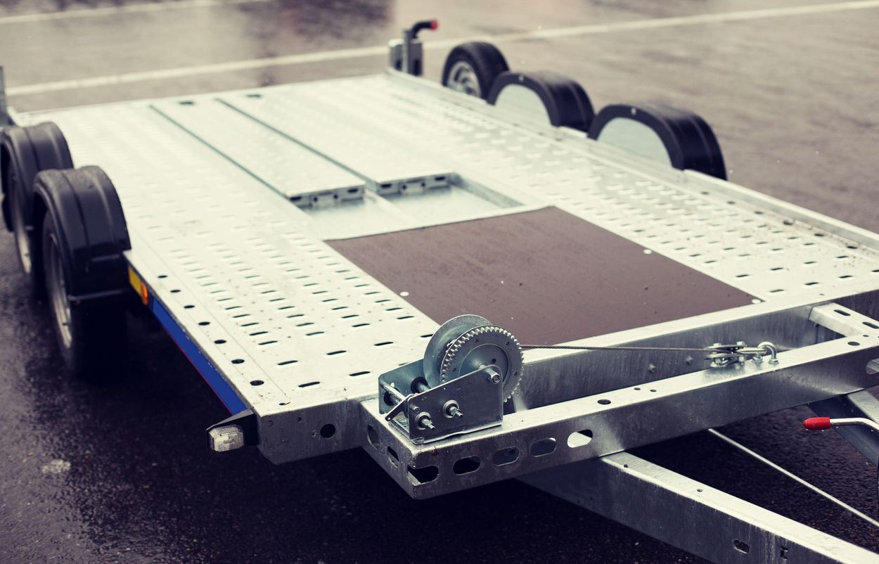 Electric flatbed robot chassis with wheels on a workbench, viewed from above