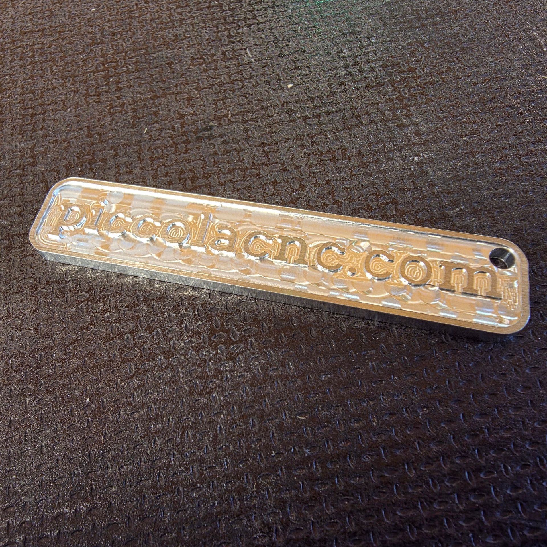 Milled aluminium keychain with piccolacnc carving.