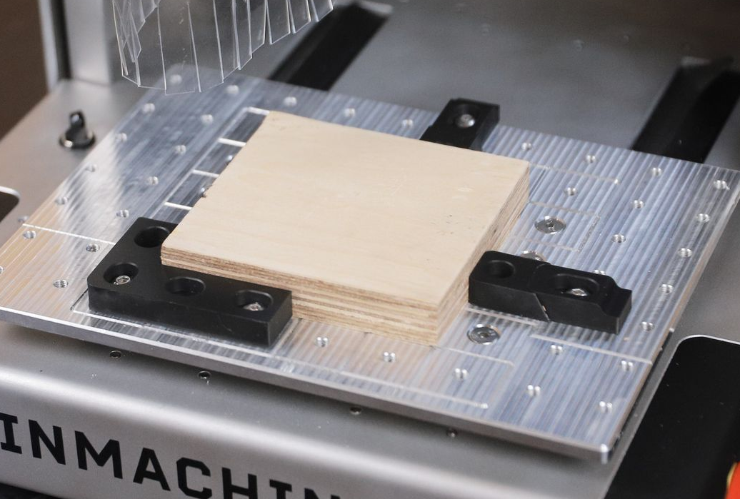 Clamping system holding a wood block.