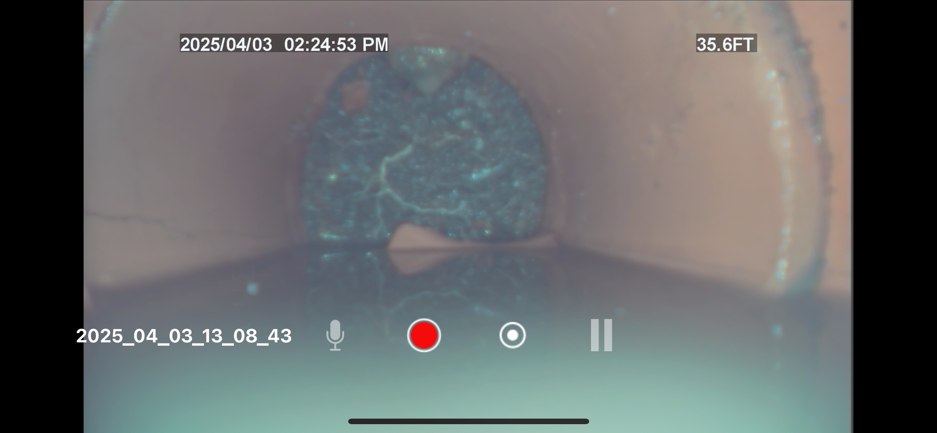 Close-up of a CCTV camera view of a fully obstructed sewer pipe