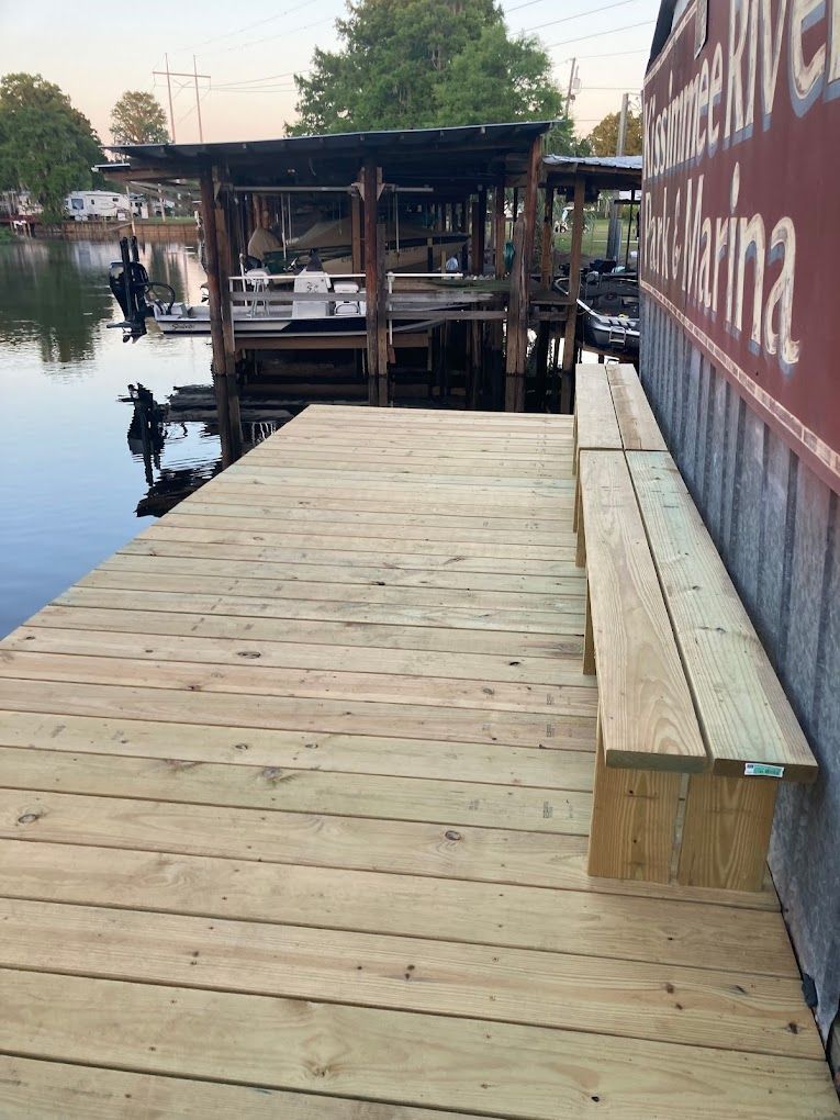 A wooden dock with a sign that says marina on it