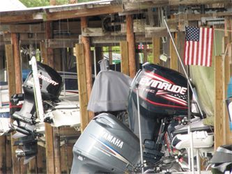 A yamaha outboard motor is parked next to a mercury outboard motor