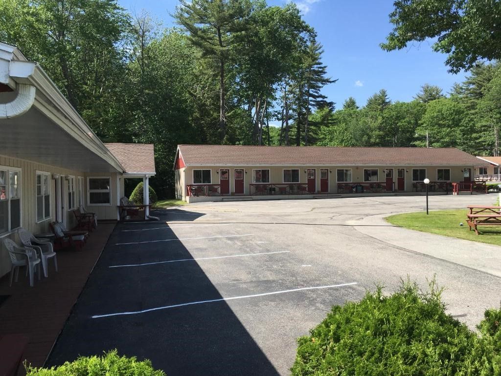A motel with a picnic table in front of it