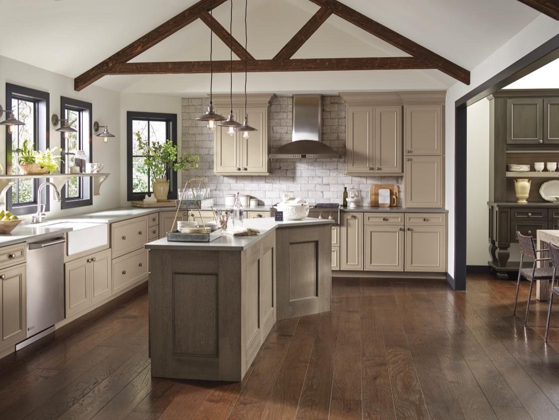 A kitchen with a large island and stainless steel appliances.