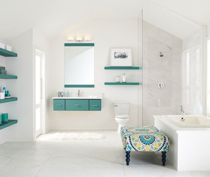 A bathroom with a tub , toilet , sink and mirror