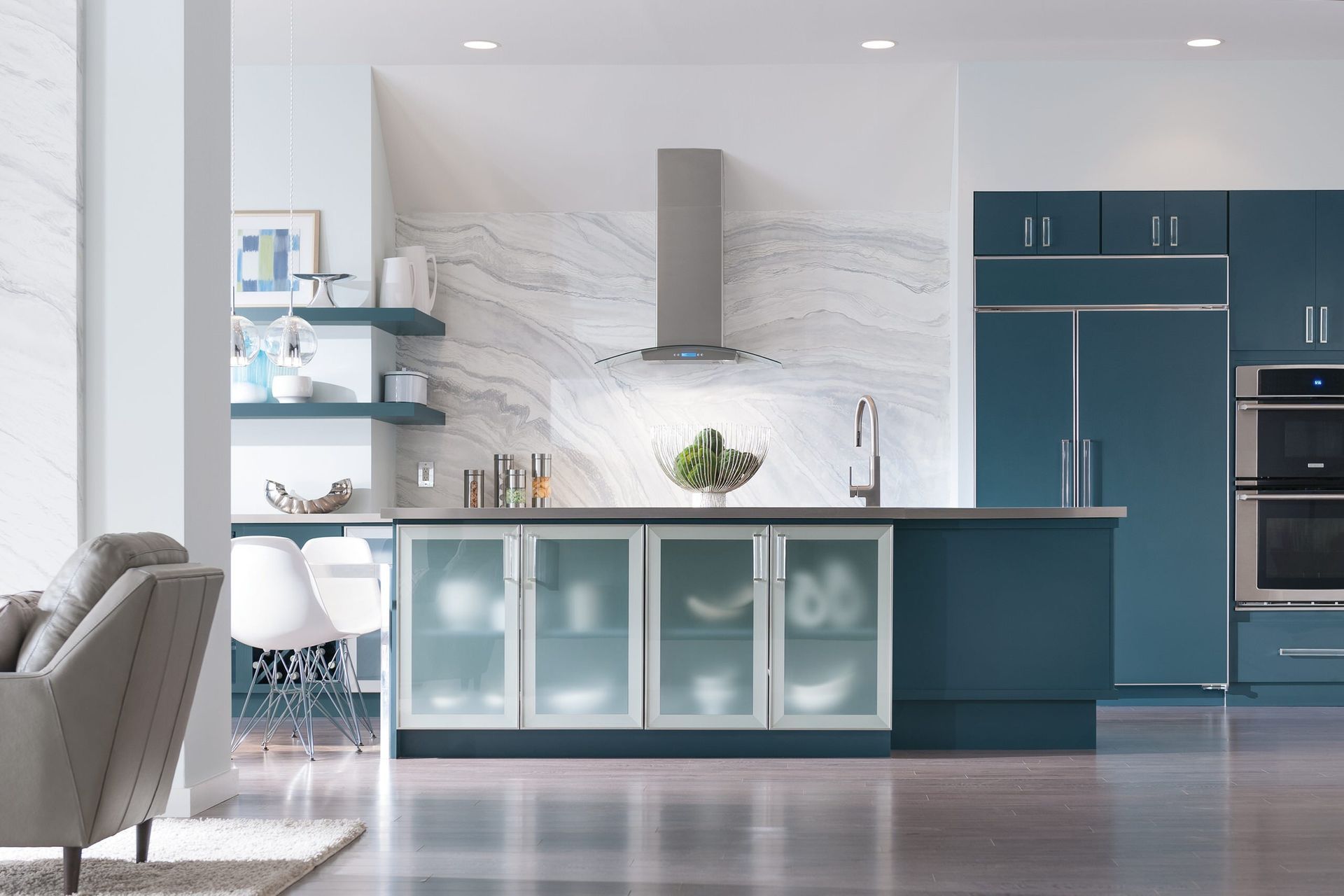 A kitchen with blue cabinets and stainless steel appliances.