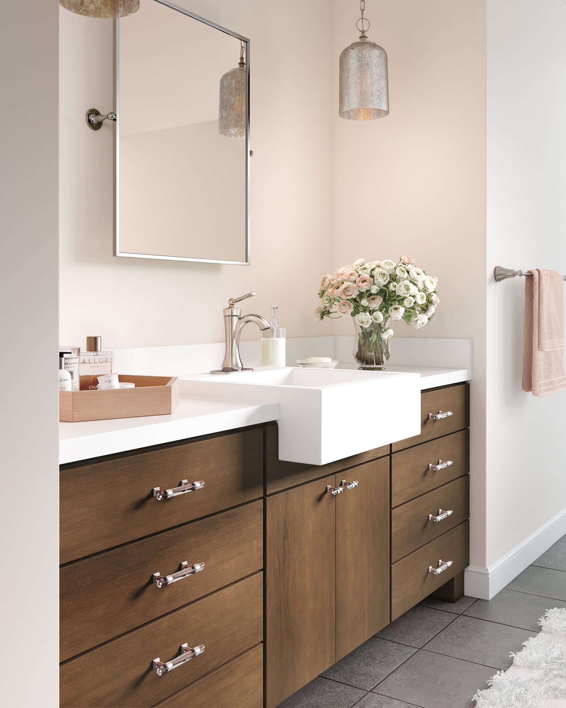 A bathroom with a sink , mirror , and wooden cabinets.