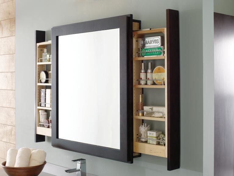 A bathroom mirror with a medicine cabinet underneath it