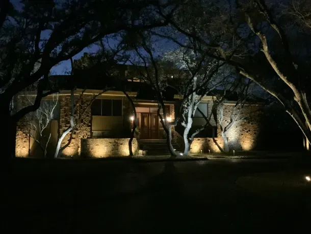 house with front yard lighting
